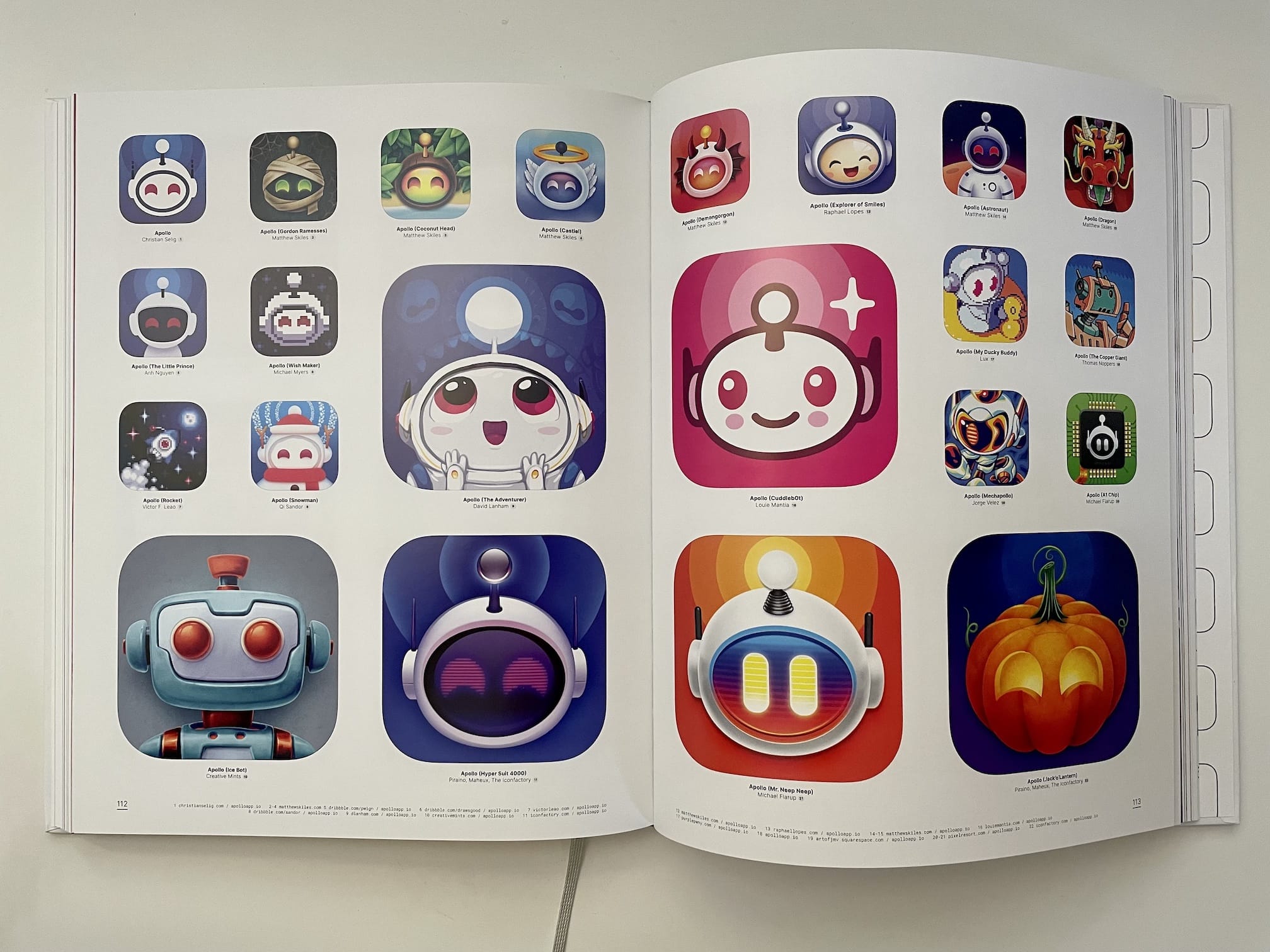 Photograph of “The App Icon Book” open to pages 112 and 113 showing variations of the “Apollo” app icon.