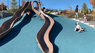 Animated gif of children at a playground sliding down on the ground instead of the playground equipment slides.